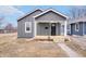 Charming gray home with a inviting front porch and well-maintained yard at 1829 New St, Indianapolis, IN 46203