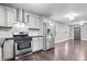 Open kitchen layout with stainless steel appliances, ample counter space, and hardwood floors at 1829 New St, Indianapolis, IN 46203