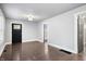 Open-concept living area featuring hardwood floors, a stylish front door, and neutral walls at 1829 New St, Indianapolis, IN 46203