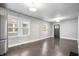 Spacious living area with hardwood floors, and views to the kitchen and front door at 1829 New St, Indianapolis, IN 46203