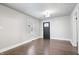 Bright living area with hardwood floors, a classic front door, and neutral color scheme at 1829 New St, Indianapolis, IN 46203