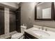 Basement bathroom with dark tile shower and modern vanity at 2016 Central Ave, Indianapolis, IN 46202