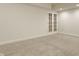 Finished basement room featuring French doors and neutral decor at 2016 Central Ave, Indianapolis, IN 46202
