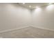 Large finished basement room with neutral walls and carpet at 2016 Central Ave, Indianapolis, IN 46202