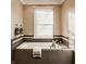 Relaxing bathroom with soaking tub and dark brown tile surround at 2016 Central Ave, Indianapolis, IN 46202