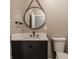 Modern bathroom with a white sink, dark vanity, and toilet at 2016 Central Ave, Indianapolis, IN 46202