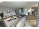 Spacious living room with large sectional sofa, hardwood floors, and an open layout to the kitchen and staircase at 2413 Griton Ct, Shelbyville, IN 46176
