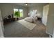 Serene main bedroom with neutral tones, large window view, and elegant furnishings at 2413 Griton Ct, Shelbyville, IN 46176