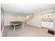 Finished basement with ping pong table, carpet, wet bar with cabinets, and lighting at 8528 Quail Hollow Rd, Indianapolis, IN 46260