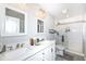 Bathroom featuring double vanity sinks, a shower, and modern fixtures at 8528 Quail Hollow Rd, Indianapolis, IN 46260