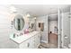 Bathroom featuring a double sink vanity with mirrors, white cabinets, and decor at 8528 Quail Hollow Rd, Indianapolis, IN 46260