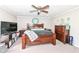 Comfortable bedroom with king bed, ceiling fan, and plenty of natural light at 8528 Quail Hollow Rd, Indianapolis, IN 46260