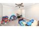 Cozy bedroom with carpet, ceiling fan, toys, and bed at 8528 Quail Hollow Rd, Indianapolis, IN 46260