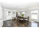 Light and bright dining room with hardwood floors and large table set for six at 8528 Quail Hollow Rd, Indianapolis, IN 46260
