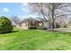 Well-maintained brick home with manicured lawn and mature landscaping in a quiet neighborhood at 8528 Quail Hollow Rd, Indianapolis, IN 46260