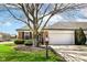 Charming brick home featuring an attached two-car garage and manicured landscaping at 8528 Quail Hollow Rd, Indianapolis, IN 46260