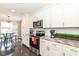 Modern kitchen with stainless steel appliances, granite countertops and white cabinets at 8528 Quail Hollow Rd, Indianapolis, IN 46260