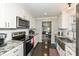 Modern kitchen featuring white cabinets, stainless steel appliances, and granite countertops at 8528 Quail Hollow Rd, Indianapolis, IN 46260