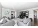 Cozy living room featuring hardwood floors, stylish gray couches and a large television at 8528 Quail Hollow Rd, Indianapolis, IN 46260
