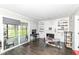 Bright living room with built-in shelving, fireplace, and sliding glass doors to the backyard at 8528 Quail Hollow Rd, Indianapolis, IN 46260