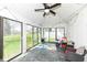 Bright sunroom featuring slate floors, multiple windows, and a vaulted ceiling at 8528 Quail Hollow Rd, Indianapolis, IN 46260