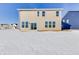 Two-story home showcasing a snowy backyard and sliding glass doors for backyard access at 1095 Bevy Blvd, Danville, IN 46122