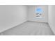 Neutral bedroom showcasing gray carpet, white walls, and a window view of the neighborhood at 1095 Bevy Blvd, Danville, IN 46122