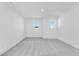 Bright bedroom with two windows, soft gray carpet, and neutral paint at 1095 Bevy Blvd, Danville, IN 46122