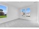 Bright bedroom with neutral carpeting, light walls and windows showing neighborhood views at 1095 Bevy Blvd, Danville, IN 46122