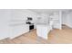 Open kitchen featuring stainless steel appliances, white cabinets and marble countertops overlooking the living space at 1095 Bevy Blvd, Danville, IN 46122