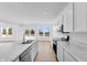 Modern kitchen with stainless steel appliances, marble counters and island flowing into living area at 1095 Bevy Blvd, Danville, IN 46122