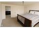Bright bedroom boasts plush carpeting, white walls, and access to an adjacent living space at 26735 Six Points Rd, Sheridan, IN 46069