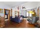 Open living room with hardwood floors, sectional sofa, and views to bedroom at 26735 Six Points Rd, Sheridan, IN 46069