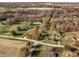 Wide aerial view showcasing multiple homes surrounded by lush greenery and mature trees, creating a serene neighborhood at 5528 Lincoln Rd, Martinsville, IN 46151