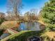 Beautiful pond with a small dock, surrounded by trees, offering a serene and private setting at 5528 Lincoln Rd, Martinsville, IN 46151