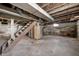Unfinished basement with exposed beams and staircase at 825 Arrow Ave, Anderson, IN 46016