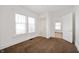 Bright bedroom features large windows, carpet, and access to another room at 825 Arrow Ave, Anderson, IN 46016