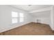 Bright bedroom features large windows, carpet, and built-in storage at 825 Arrow Ave, Anderson, IN 46016