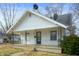 Charming single-story home featuring a covered porch and a well-maintained front yard at 825 Arrow Ave, Anderson, IN 46016