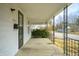 View from covered porch featuring concrete flooring, metal railing and views of the street at 825 Arrow Ave, Anderson, IN 46016