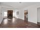 Cozy living room with hardwood floors, a brick fireplace, and plenty of natural light at 825 Arrow Ave, Anderson, IN 46016