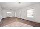 Bright living room with carpet floors, neutral walls, and natural light from multiple windows at 825 Arrow Ave, Anderson, IN 46016