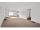 Spacious living room with carpet, neutral walls and entryways to other parts of the home at 825 Arrow Ave, Anderson, IN 46016