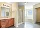 Bright bathroom with double shower stall and a soaking tub, plus stylish vanity lighting at 10034 Evening Sun Ct, Avon, IN 46123