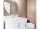 Modern powder room featuring a white vanity, a round mirror, and a toilet at 10034 Evening Sun Ct, Avon, IN 46123