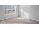 Bright bedroom with neutral walls and carpet with a large window allowing for natural light at 10034 Evening Sun Ct, Avon, IN 46123