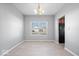 Dining room with neutral walls, tile floors, natural light, and a modern chandelier at 10034 Evening Sun Ct, Avon, IN 46123