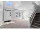 Bright foyer with high ceilings, neutral walls, a staircase, and carpeted floors at 10034 Evening Sun Ct, Avon, IN 46123