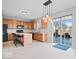 Open kitchen featuring wood cabinets, an eat-in island, stainless appliances, and access to the patio at 10034 Evening Sun Ct, Avon, IN 46123