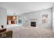 Spacious living area featuring a fireplace, large windows, and an open-concept layout to the kitchen at 10034 Evening Sun Ct, Avon, IN 46123